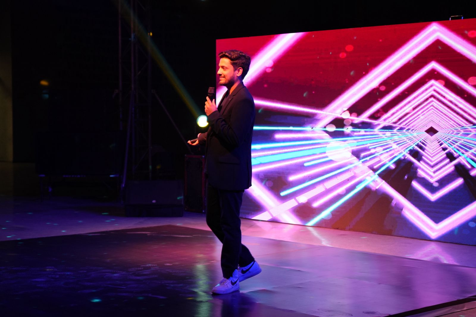 Sidhant emceeing a BITSoM event on stage